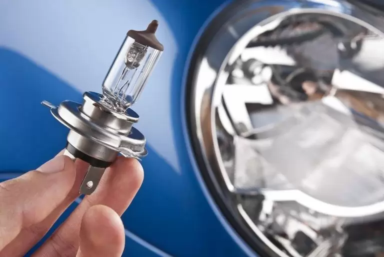 Premium Photo  Repair man hand installing halogen led bulb for car  headlights. auto light lamp technology